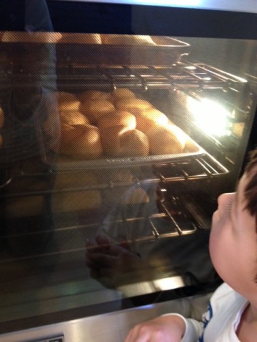 Here Noah is waiting for the rosy dough to turn golden as they puff up in the oven.