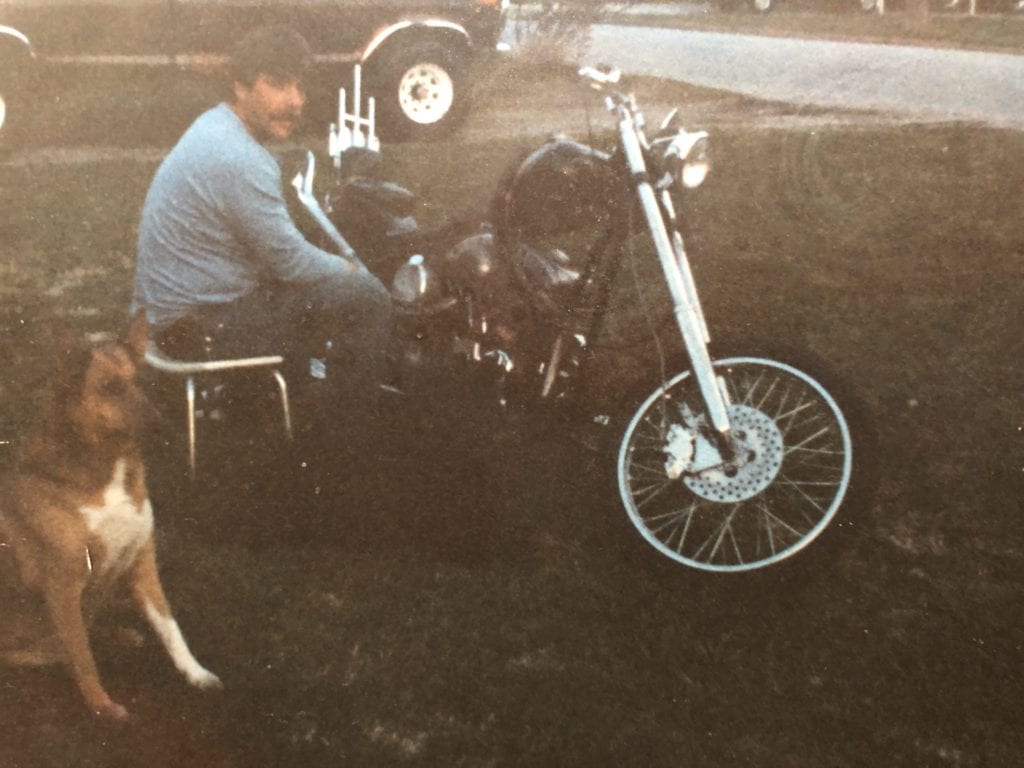 Steve with three of his favorites: his Harley, dog, and his pickup.